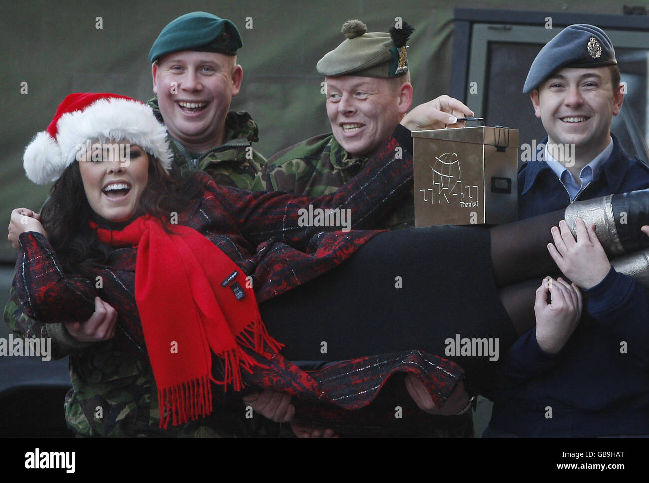 Miss UK, Nieve Jennings with, left to right, Navy LSCIS William Robertson, Army L/Cpl Shug Hughes and RAF Cpl Michael MacGillivray with Christmas gifts for soldiers in Afghanistan during a photocall outside Marks and Spencer in Glasgow. Stock Photo
