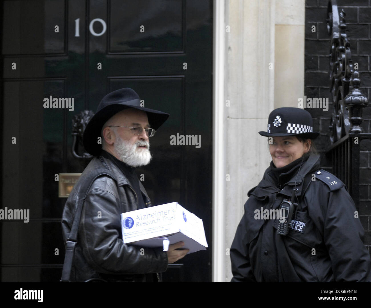 Novelist Terry Pratchett hands a petition in at 10 Downing Street, London, as he calls for more Government funding towards dementia research. Stock Photo