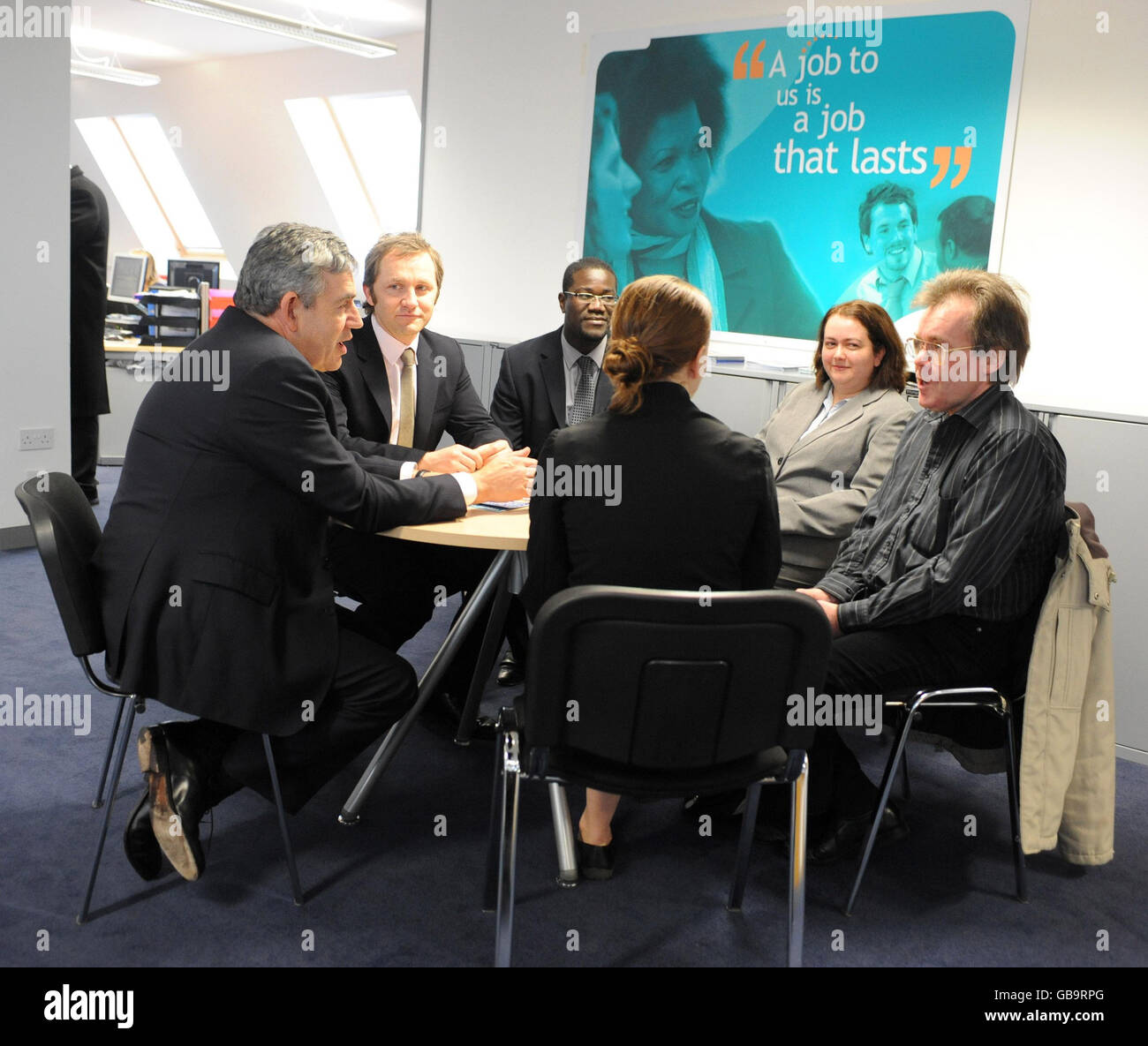 Britain's Prime Minister Gordon Brown (left) and Work and Pensions Secretary James Purnell (second left) during a visit to Work Directions in London's King's Cross, which is a private sector organisation providing employment support and advice to those on incapacity benefit or income support. Stock Photo