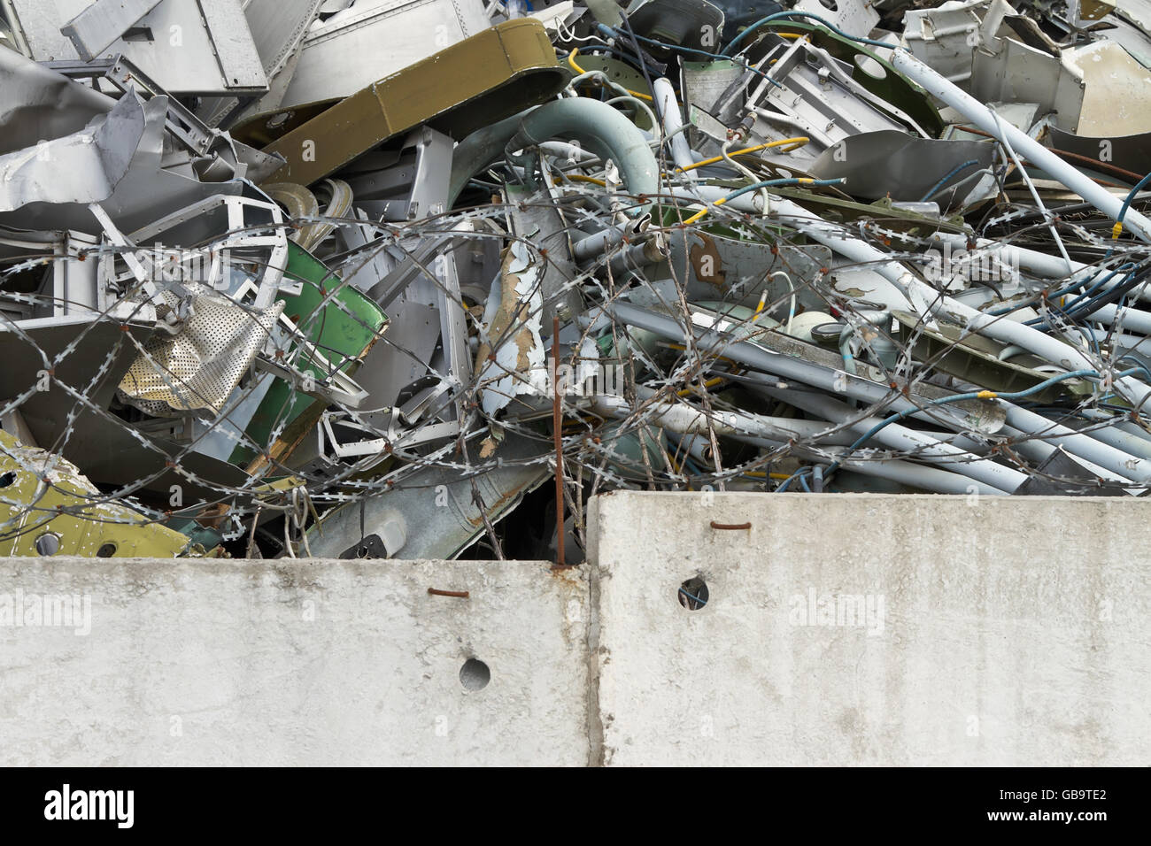 Garbage dump behind a concrete fence Stock Photo Alamy