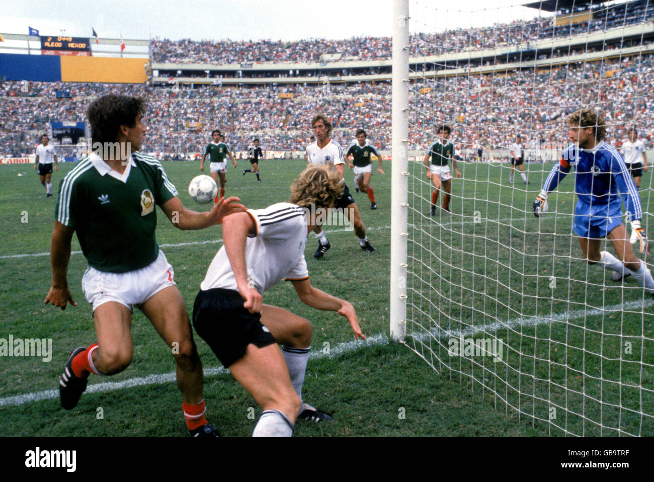 West Germany's Harald Schumacher (r), Andreas Brehme (second l) and Ditmar Jakobs (second r) react as the ball stays in play Stock Photo