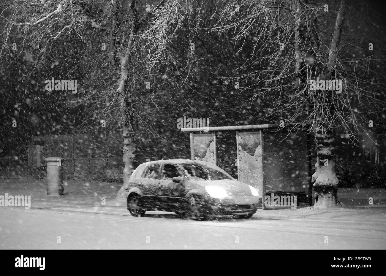 Snow in the UK. Heavy snow falls as people make their way to work in Harrogate. Stock Photo