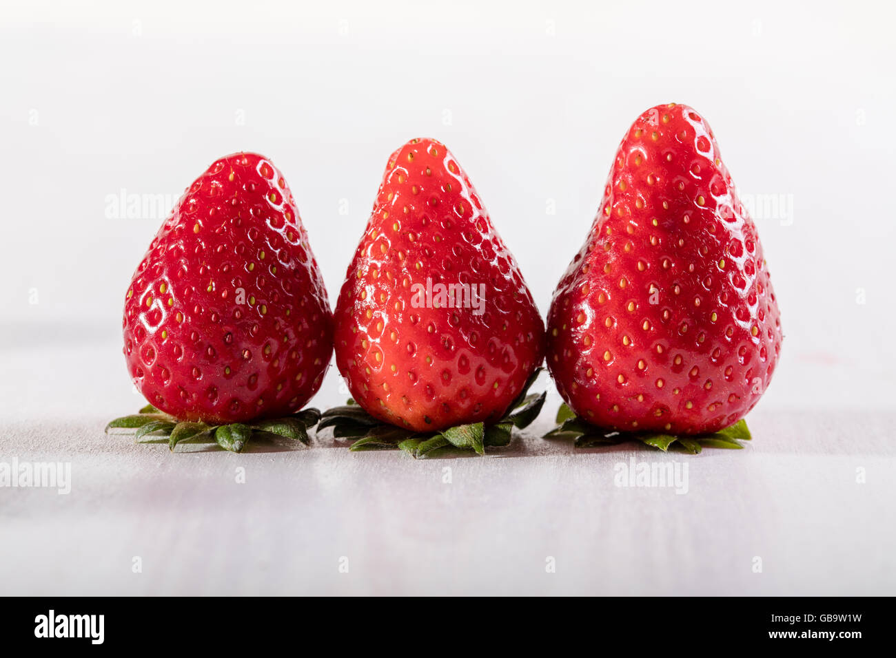 Three juicy strawberry on the table Stock Photo