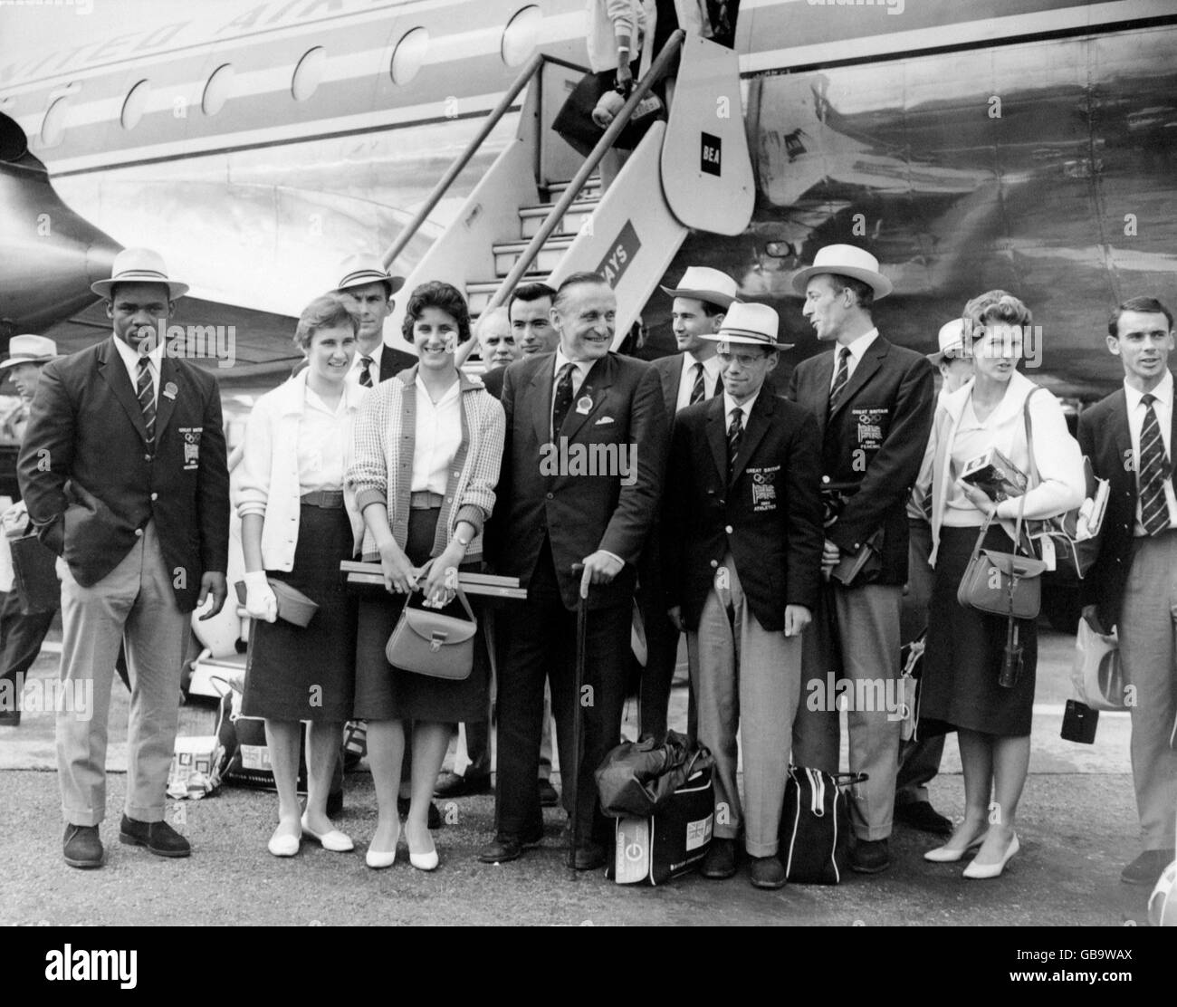 (L-R) Some of the British medallists pictured upon their arrival at London Airport: weightlifter Louis Martin (bronze), high jumper Dorothy Shirley (silver), 100m runner Dorothy Hyman (silver), Lord Burghley, The 6th Marquis of Exeter, 50km walker Don Thompson (gold), a fencer and 80m hurdler Carol Quinton (silver) Stock Photo