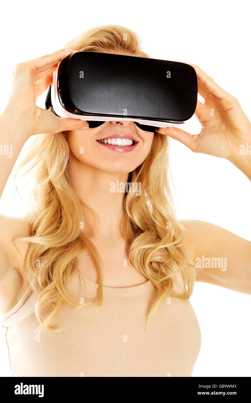 Happy woman wearing virtual reality goggles Stock Photo