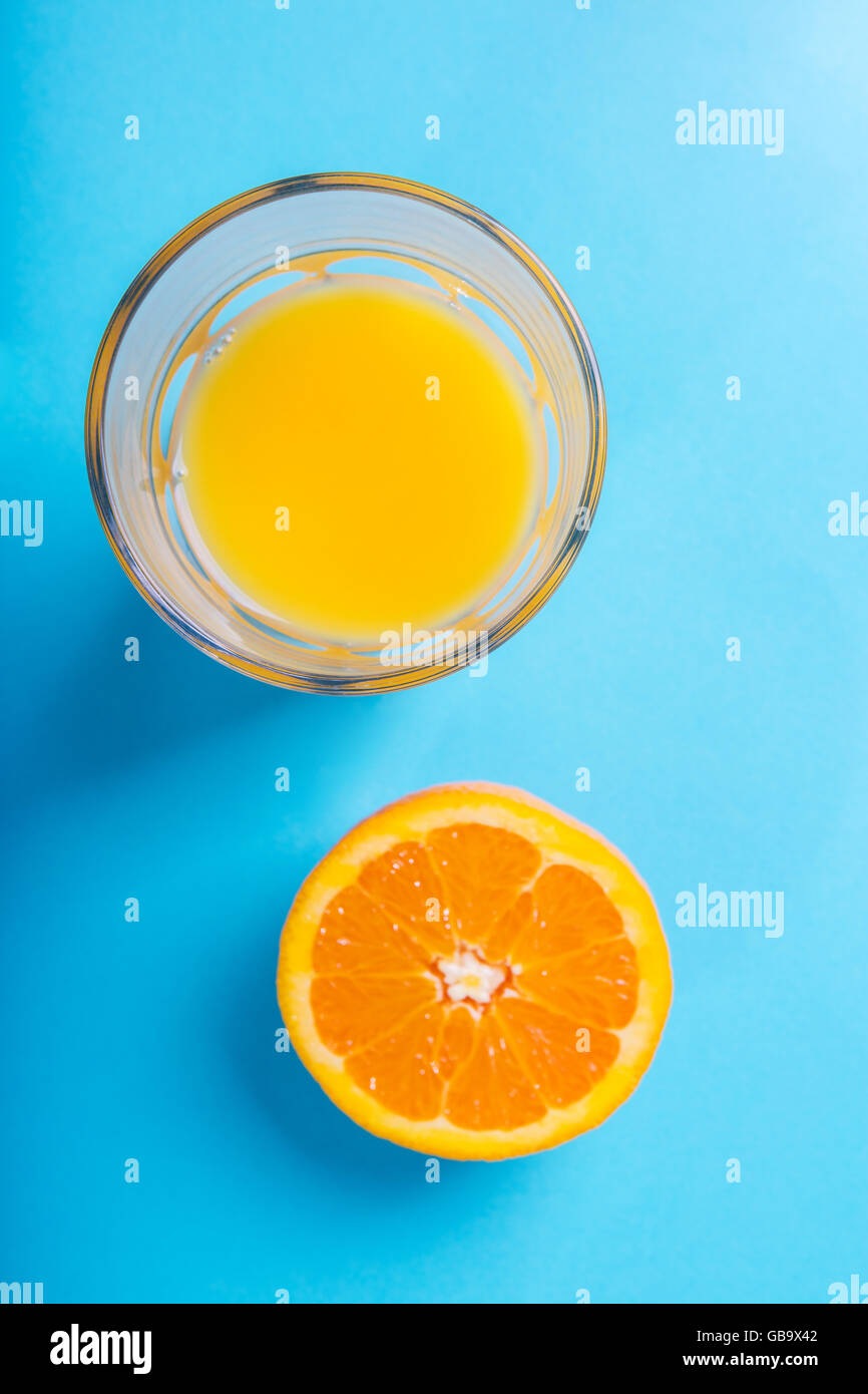 Glass of orange juice and half of orange Stock Photo