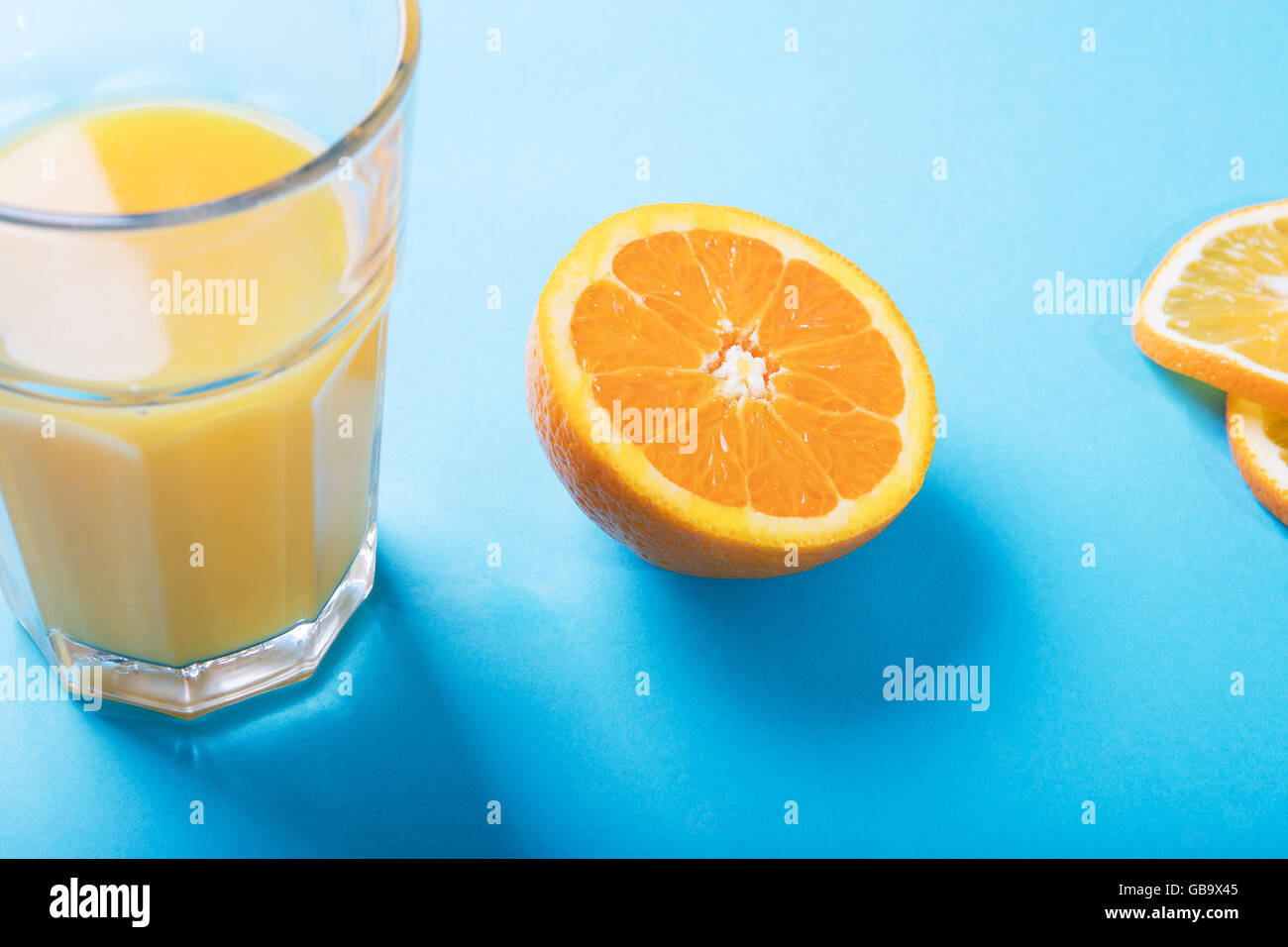 Glass of orange juice, half of orange and oranges slices Stock Photo