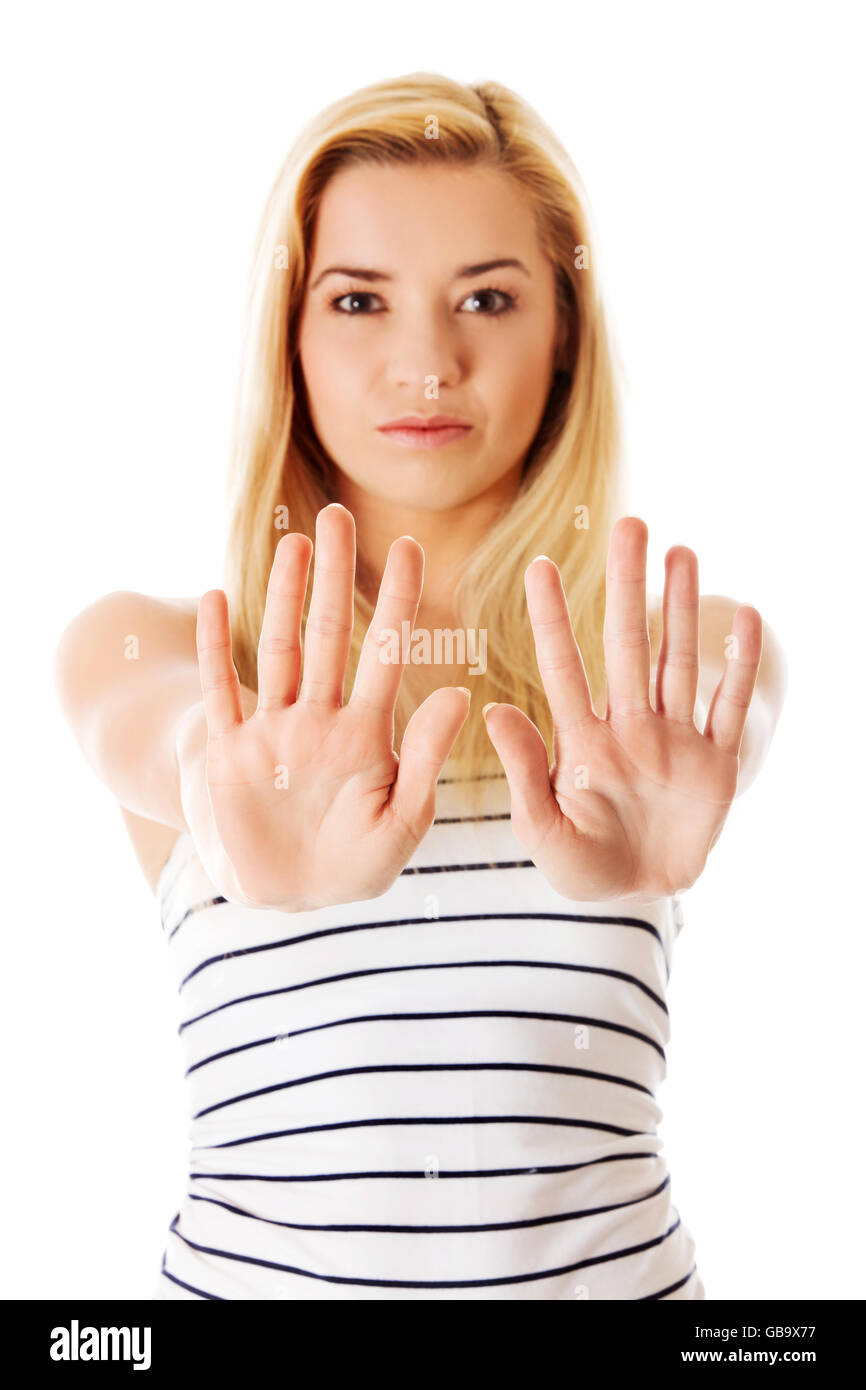 Young woman making stop sign on white background. Stock Photo