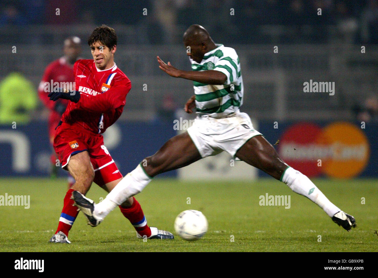 Olympique Lyonnais' Juninho Pernambucano and Celtic's Bobo Balde (r) battle for the ball Stock Photo