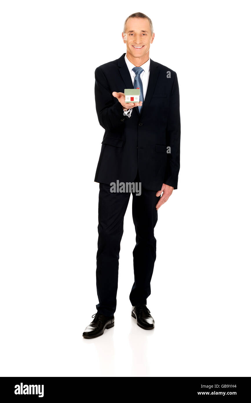 Businessman holding house model Stock Photo - Alamy