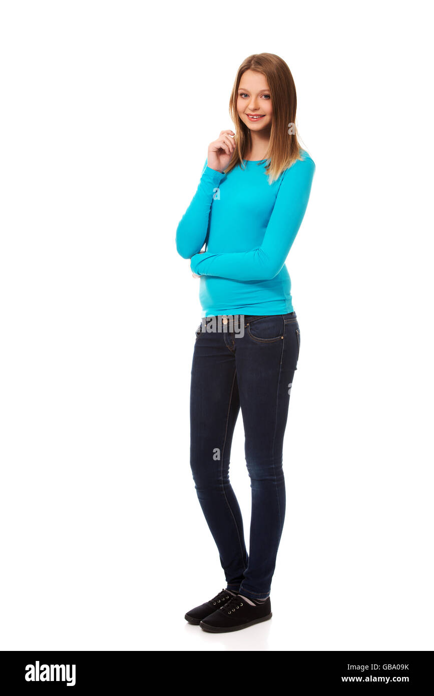 A beautiful young teenage girl standing in black leather pants holding in a  book in her hands, smiling, isolated for white background Stock Photo -  Alamy