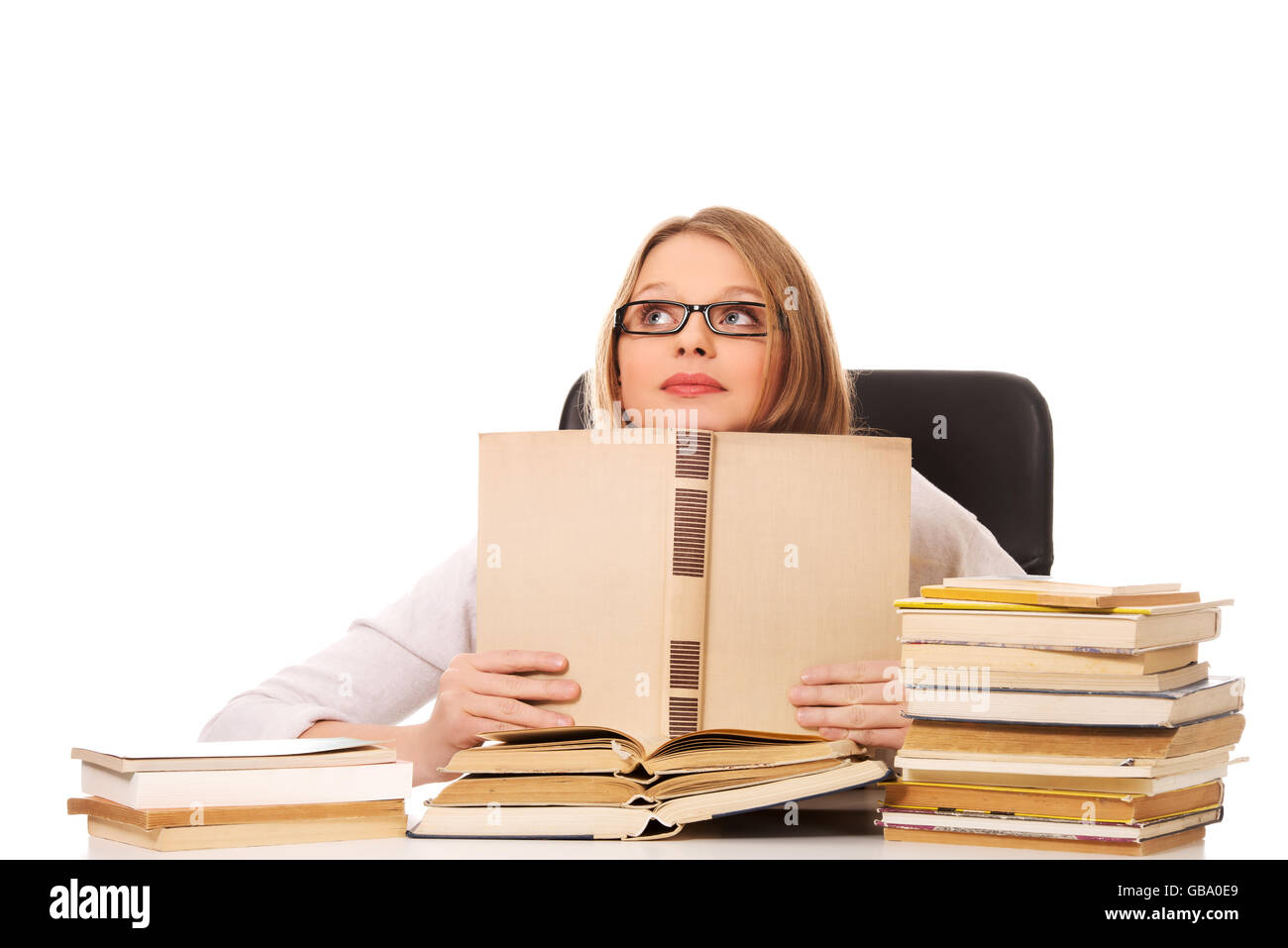 Young woman with a books pile Stock Photo - Alamy