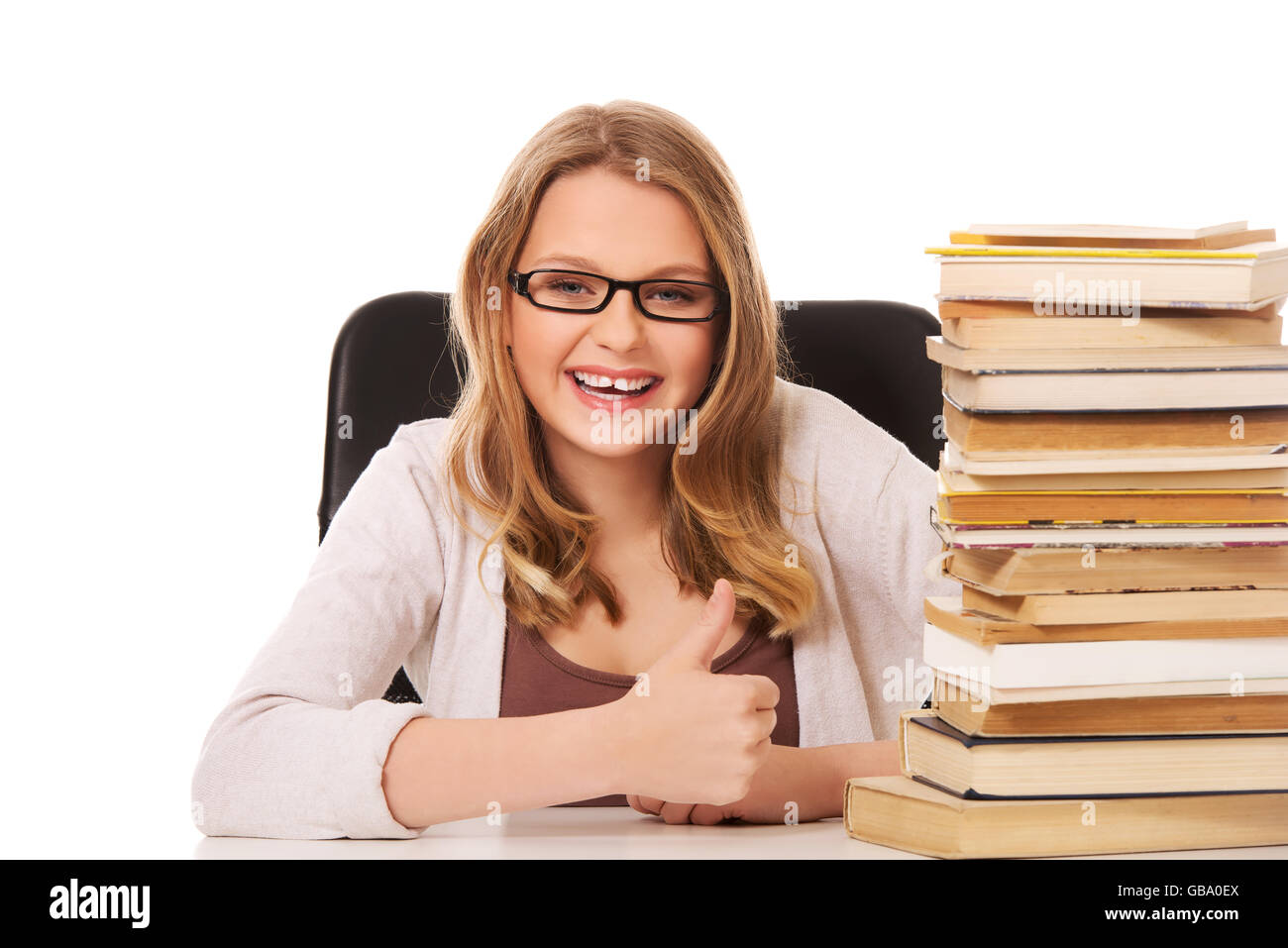 Young woman with a books pile Stock Photo - Alamy