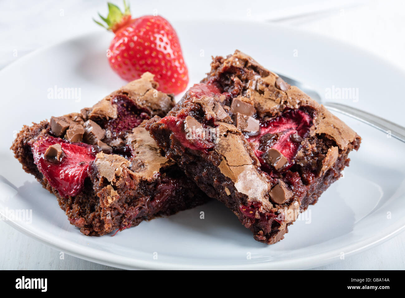 Chocolate cake with strawberry on porcelain plate Stock Photo - Alamy
