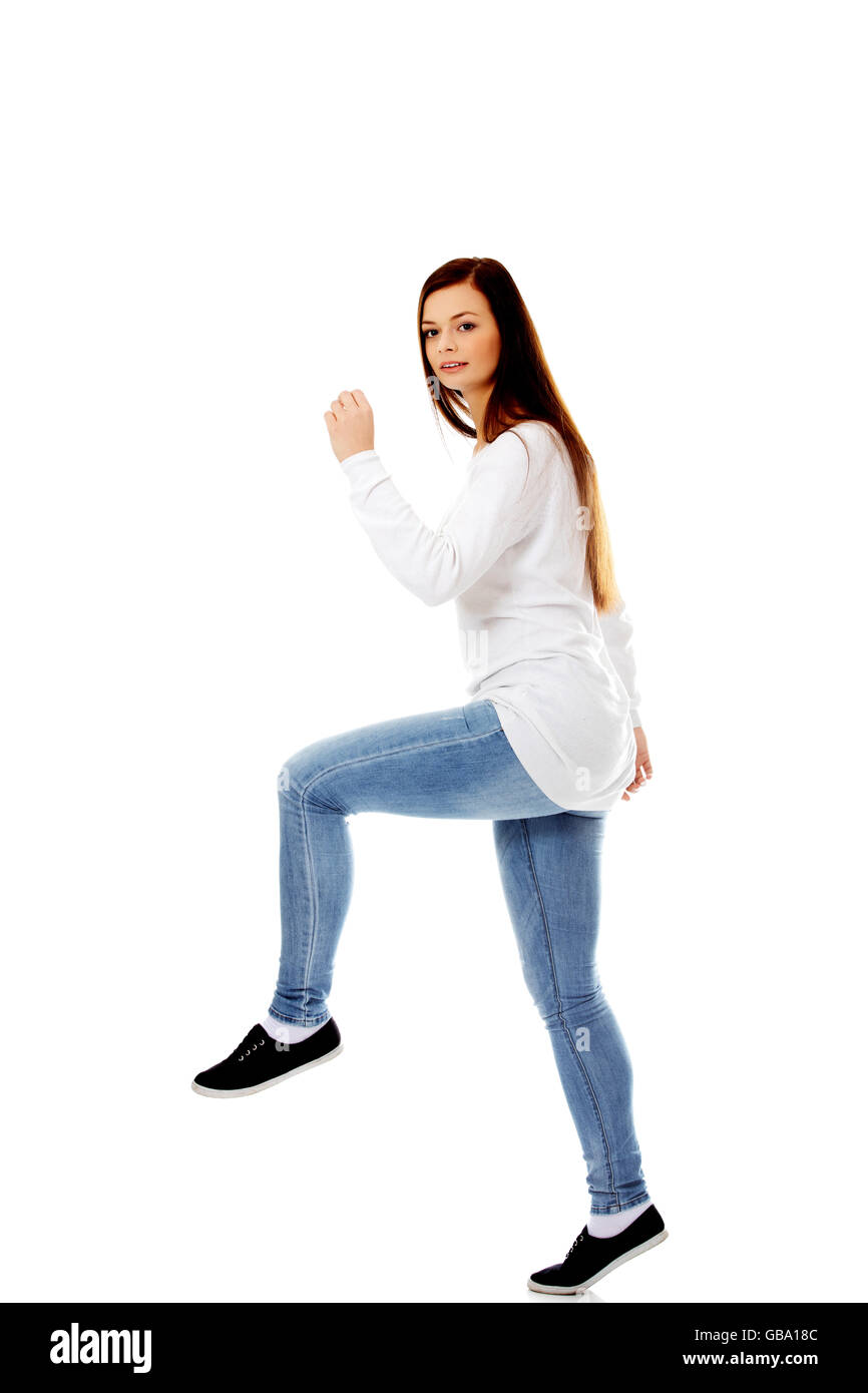 Young woman trying to trample something Stock Photo