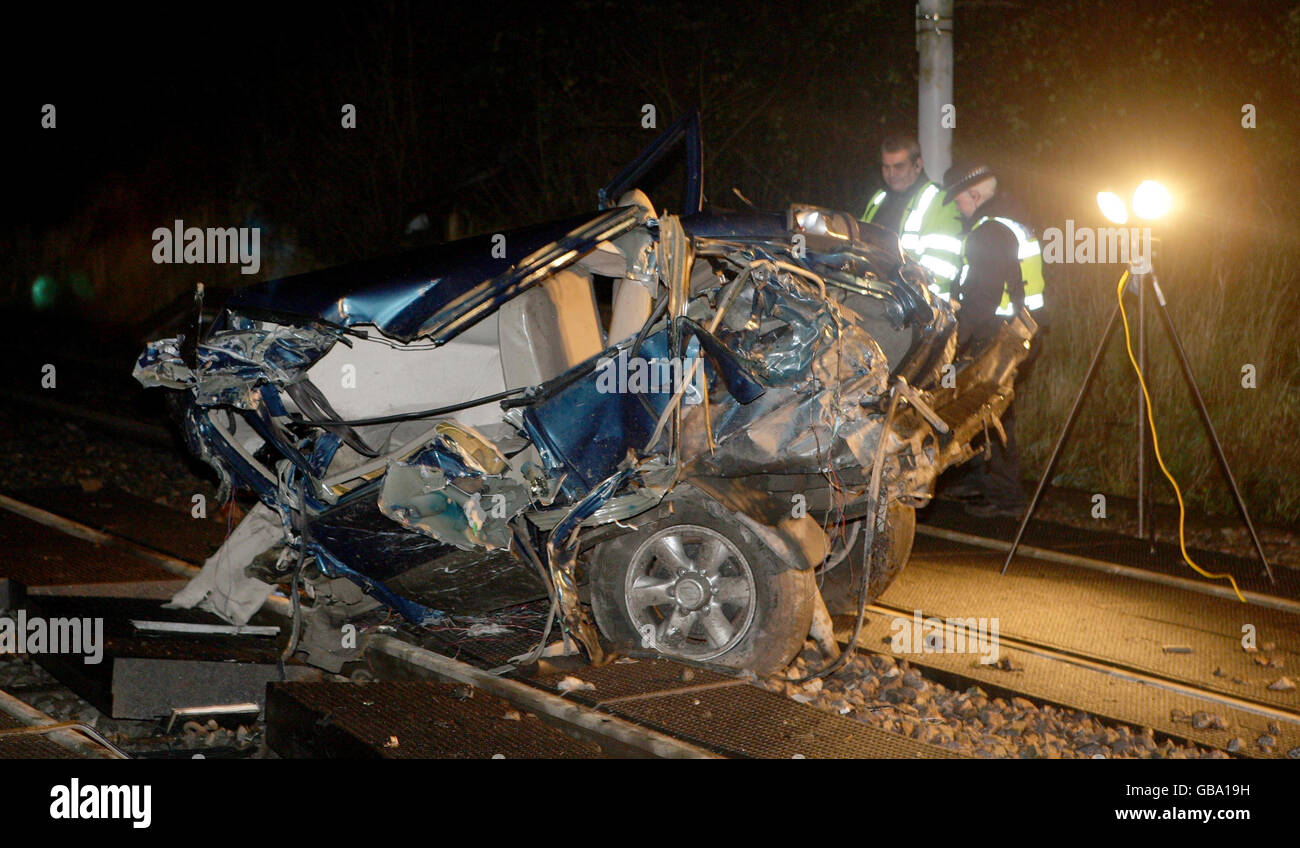 Train hits empty car on track Stock Photo - Alamy