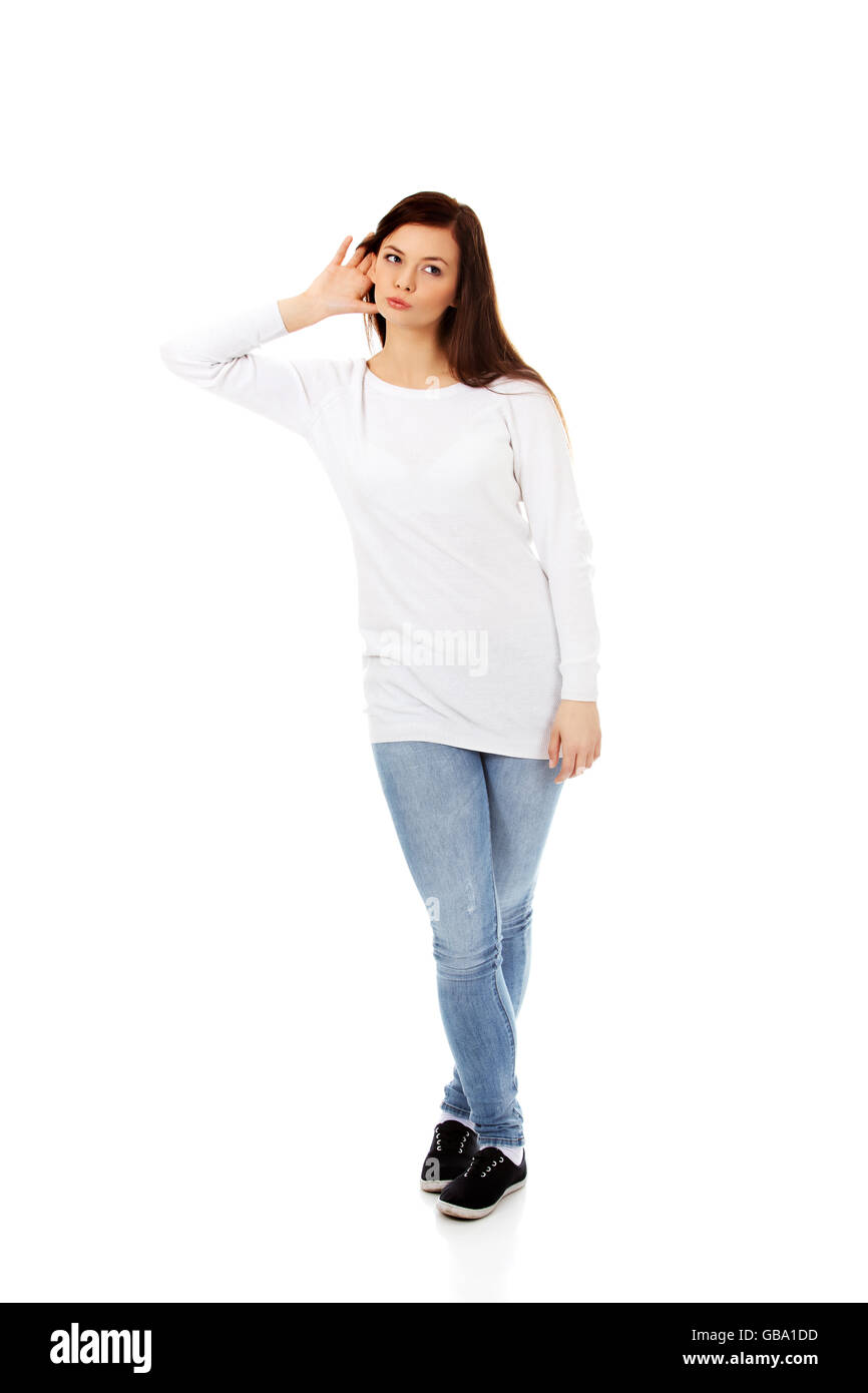 Shocked young woman overhearing a conversation Stock Photo - Alamy