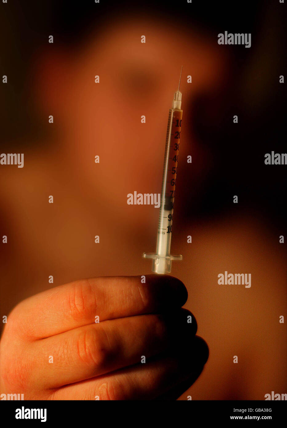 An addict holds up a needle before injecting heroin in the town of Portlaoise, Co Laois, where outreach workers believe up to 600 users could be taking heroin behind closed doors. Stock Photo