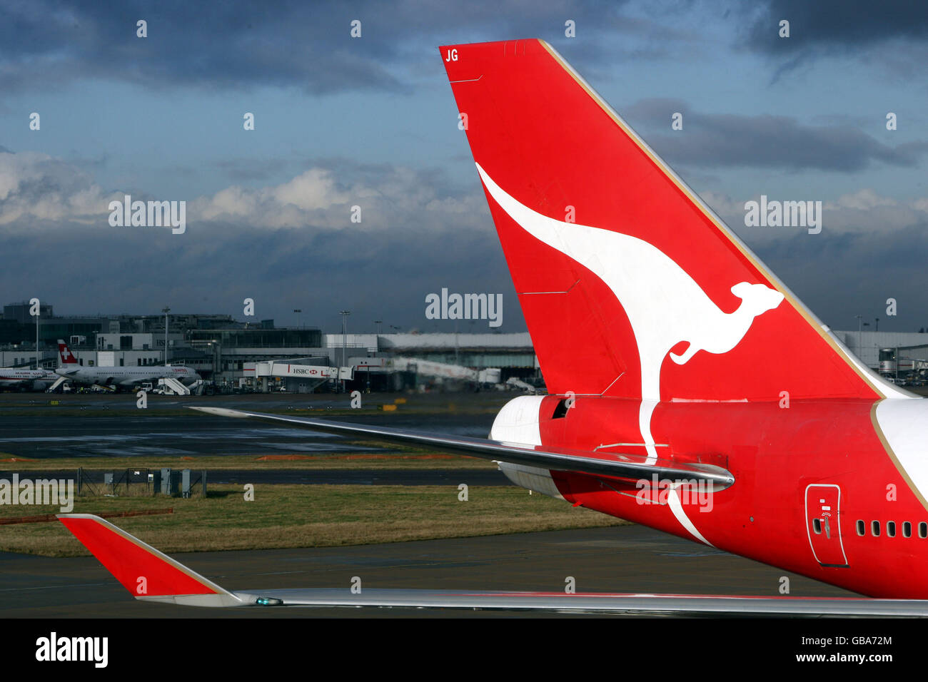 A Qantas plane sits at Terminal 4 of Heathrow Airport as a giant new airline could be formed following news that British Airways is in talks about a possible merger with the Australian carrier. Stock Photo