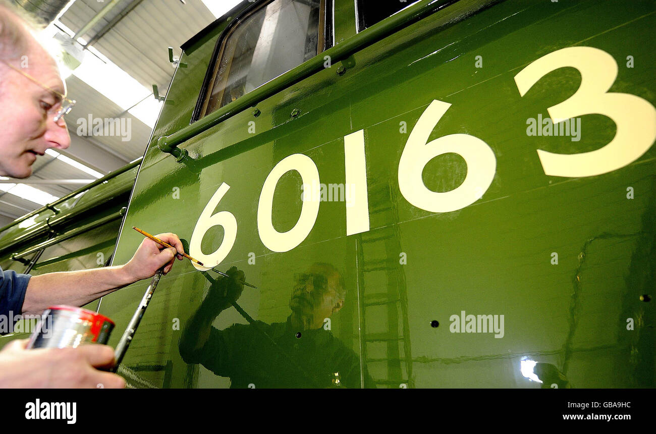 Paint and livery specialist of York's National Railway Museum, Tony Filby, puts the finishing touches to the engine number on the first steam train to be built in the UK for over 40 years, the Tornado Steam Locomotive. Stock Photo