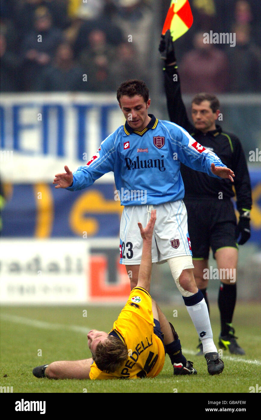 Soccer - Italian Serie A - Modena v Chievo. Modena's Nicola Campedelli lies injured after a challenge by Chievo's Salvatore Lanna (top) Stock Photo