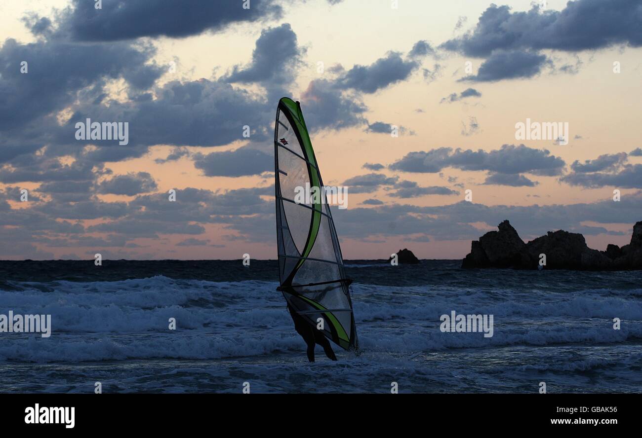 General view of a windsurfer in the breakers off Golden Bay, Malta Stock Photo