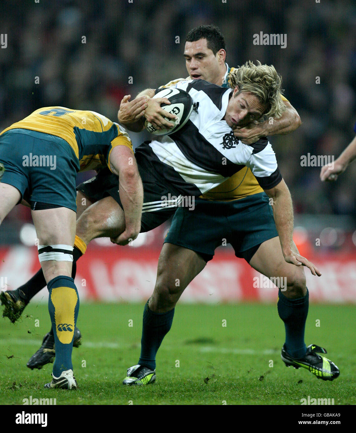 Rugby Union - BOA Centenary Celebration Match - Barbarians v Australia - Wembley Stadium. Barbarian's Percy Montgomery is floored by Australia's Richard Brown (L) and George Smith (R). Stock Photo