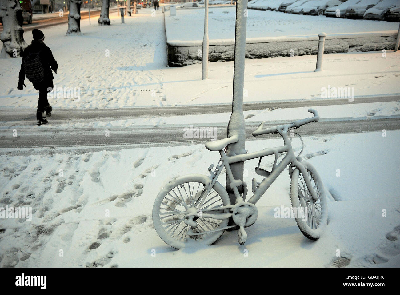 A bike is covered in snow as people make their way to work in Harrogate. Stock Photo