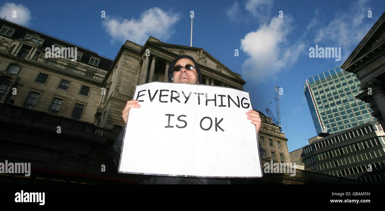 A protester outside the Bank of England in London, as interest rates are cut. Stock Photo