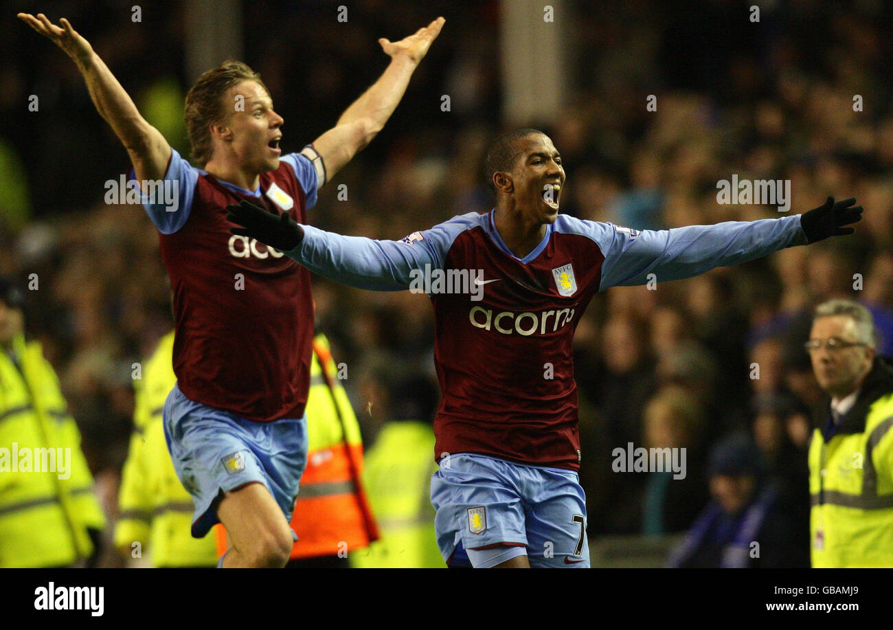Match-winner Aston Villa's Ashley Young celebrates in front of the Villa fans with teammate Martin Laursen at the final whistle after scoring with 12 seconds to go to make the score 3-2 in their favour, following the Barclays Premier League match at Goodison Park, Liverpool. Stock Photo