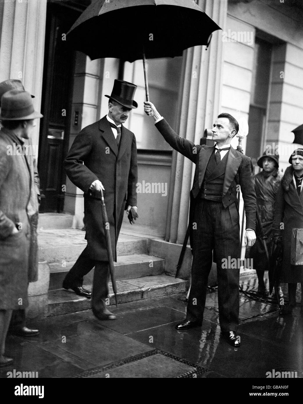 Neville Chamberlain, Chancellor of the Exchequer, leaving to present his second budget at the House of Commons. Stock Photo