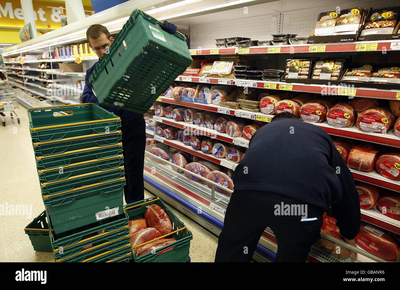 Staff empty pork shelves at a Tesco store in Newtownbreda, Belfast, as