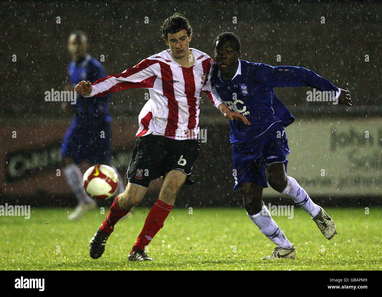 Birmingham City's Akwasi Asante and Lincoln's Greg Enstone compete for the ball Stock Photo