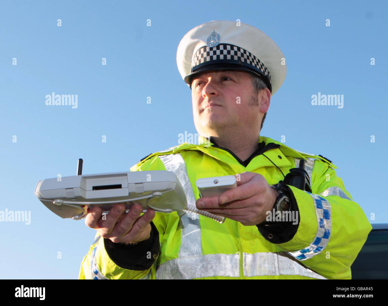 Lothian and Borders police officer Tom Boyle demonstrates using Bluetooth message equipment