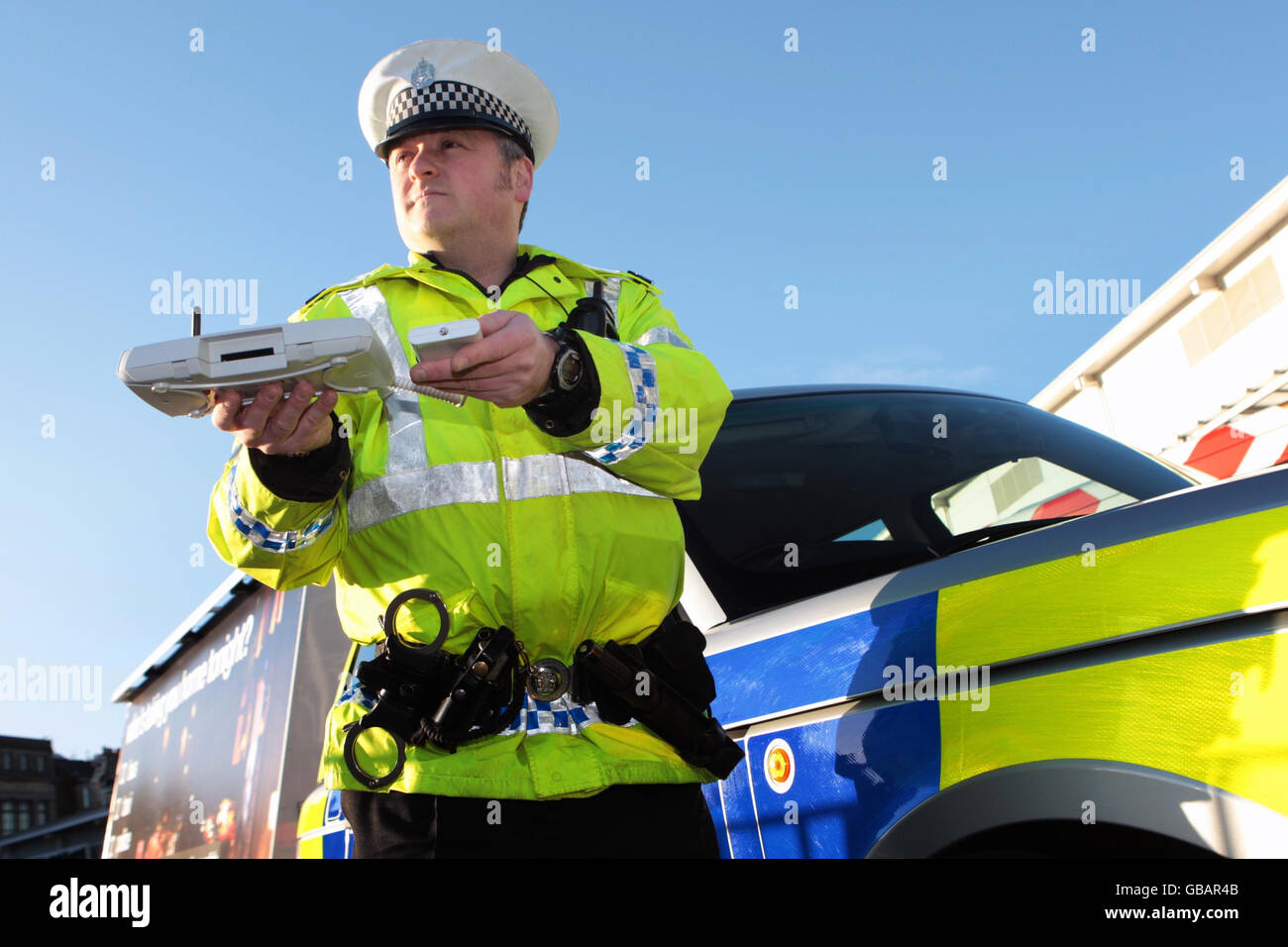 Lothian and Borders police officer Tom Boyle demonstrates using Bluetooth message equipment