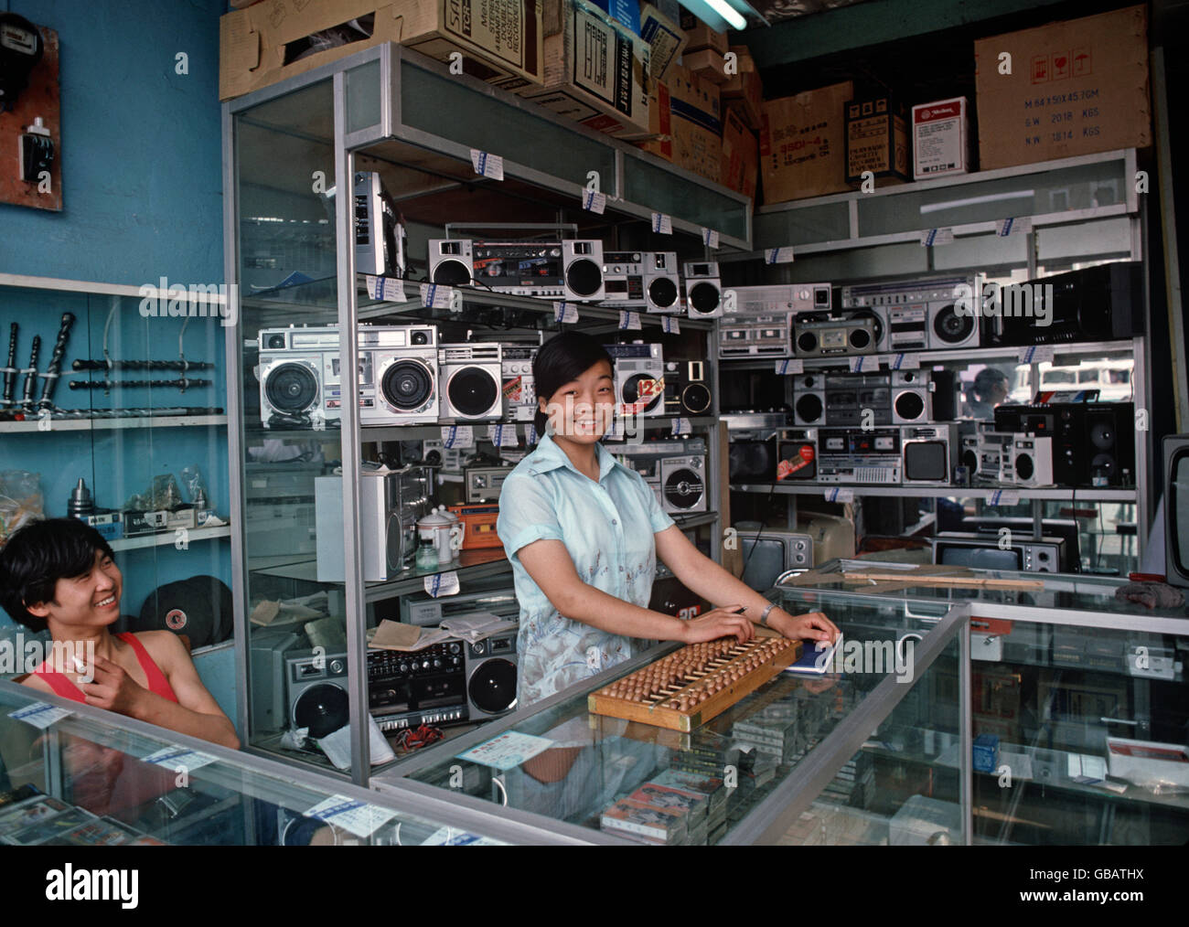 Chinese woman with wooden abacus in electronic shop, Chengdu market, Sichuan Province, China Stock Photo