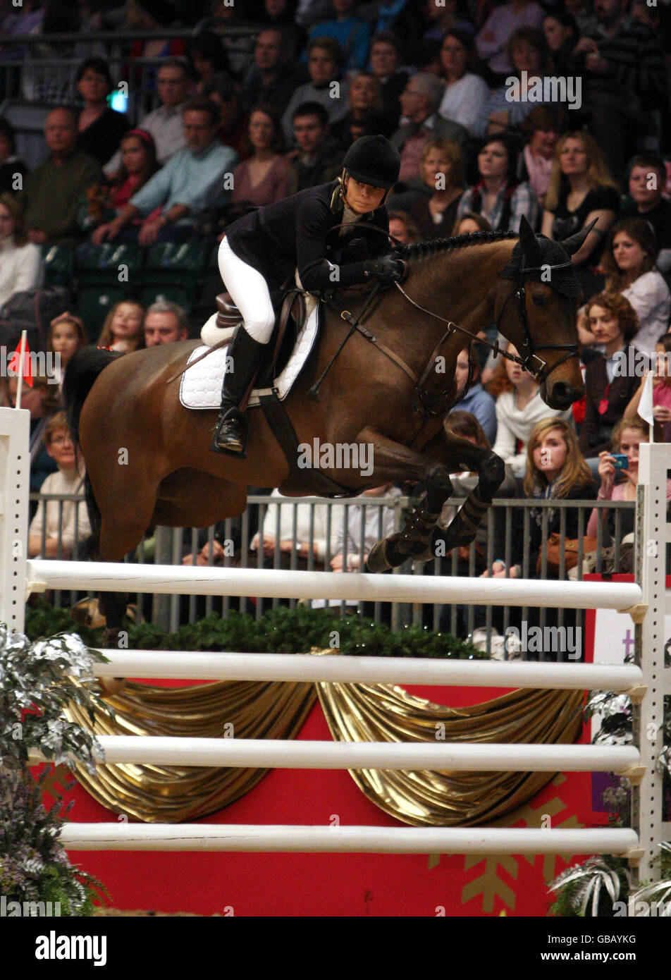 Edwina Alexander from Australia riding Nellypso des Horts competes in the KBIS Christmas Pudding Speed Stakes on the third day of Olympia The London International Horse Show being held at the Olympia Exhibition Centre in West London. Stock Photo