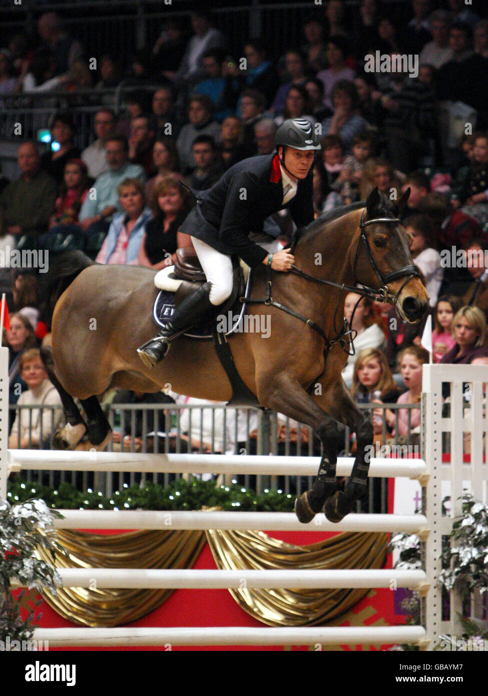 Mikael Forsten from Finland riding Vanity 16 competes in the KBIS Christmas Pudding Speed Stakes on the third day of Olympia The London International Horse Show being held at the Olympia Exhibition Centre in West London. Stock Photo