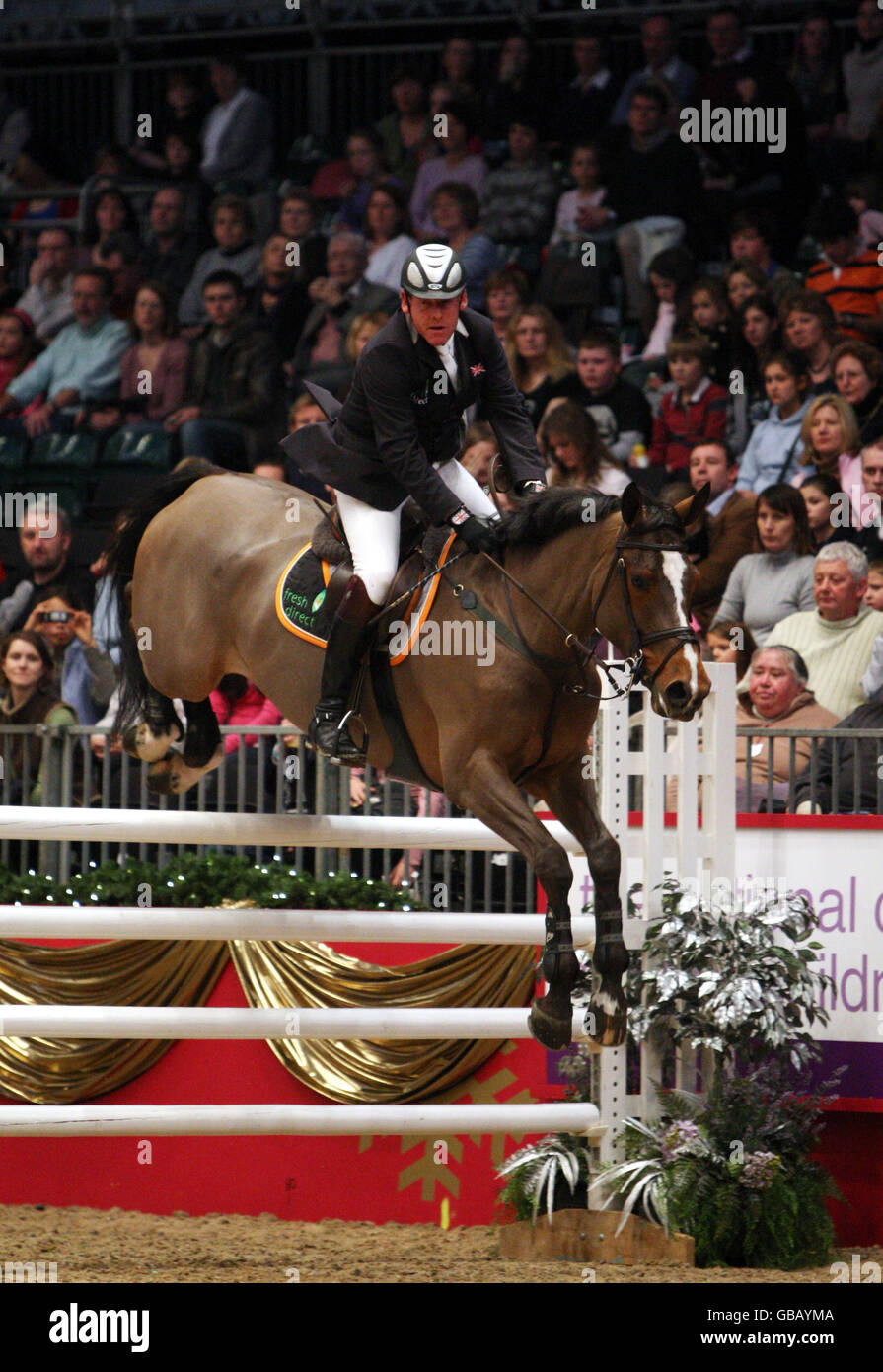 Tim Stockdale from Great Britain riding Fresh Direct Talori competes in the KBIS Christmas Pudding Speed Stakes on the third day of Olympia The London International Horse Show being held at the Olympia Exhibition Centre in West London. Stock Photo