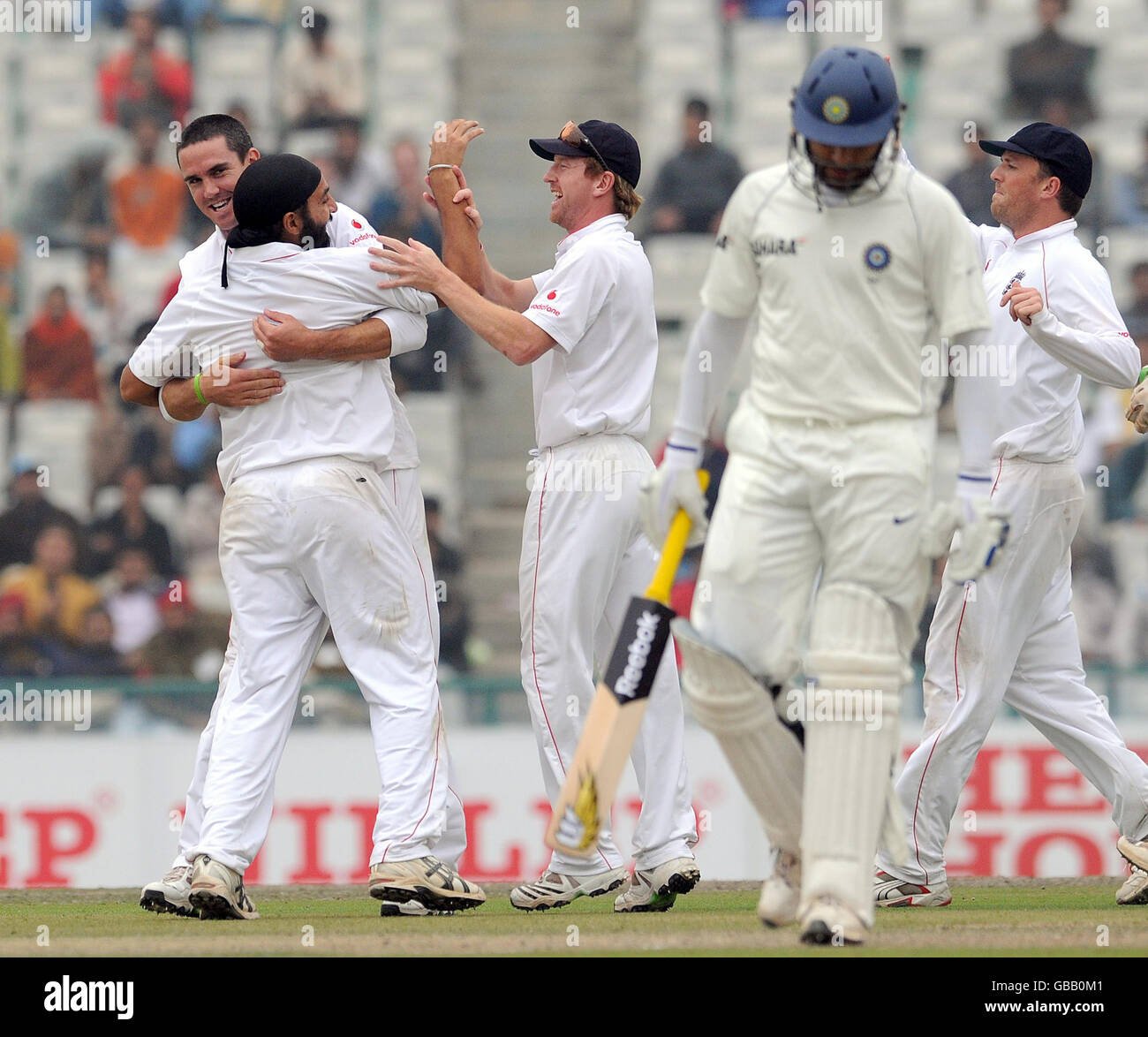England's Monty Panasar celebrates with Kevin Pietersen after taking the wicket of Yuvraj Singh, caught by Matt Prior for 27 during the second day of the second test at the Punjab Cricket Association Stadium, Mohali, India. Stock Photo