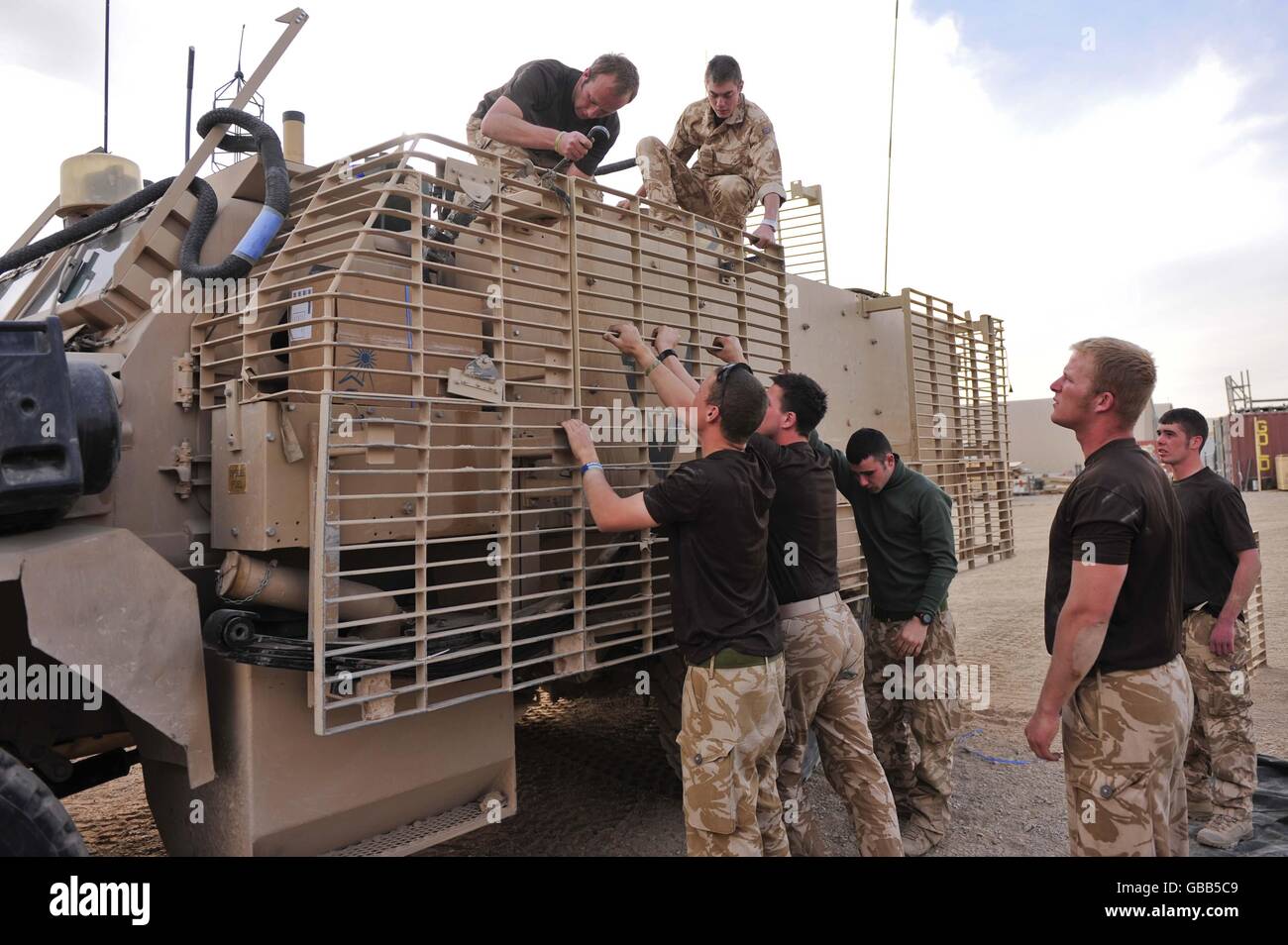 Troops from 1st The Queen's Dragoon Guards refit a Mastiff armoured vehicle in Camp Bastion Afghanistan. Stock Photo