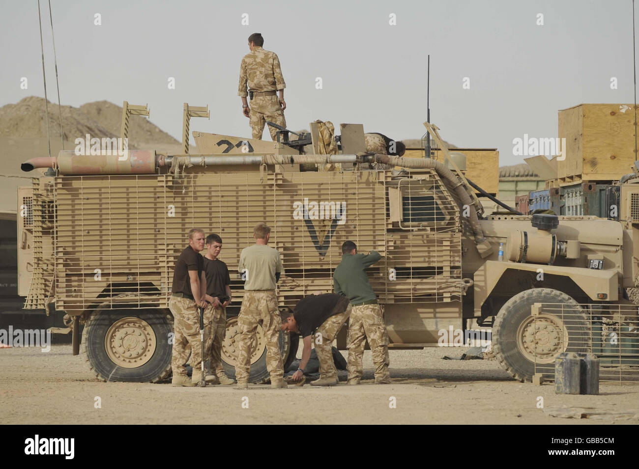 Troops from 1st The Queen's Dragoon Guards refitting a Mastiff armoured vehicle in Camp Bastion Afghanistan. Stock Photo