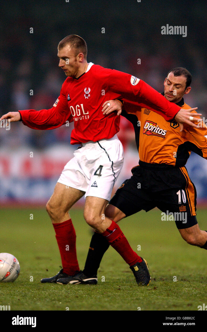Kidderminster Harriers' Danny Williams (l) shields the ball from Wolverhampton Wanderers' Colin