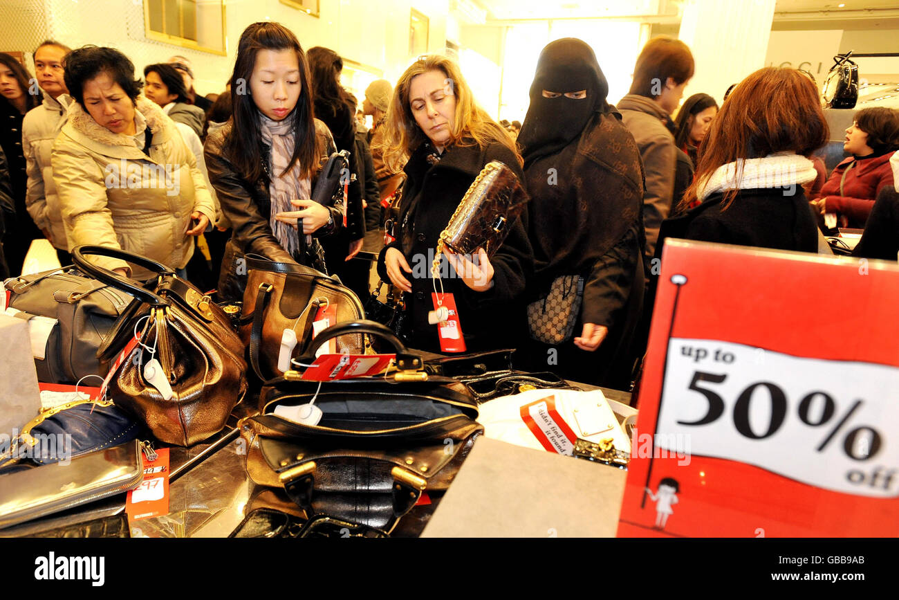 Shoppers search through the handbags at Selfridges store in Oxford Street central London, as the start of the Selfridges sale gets under way. Stock Photo