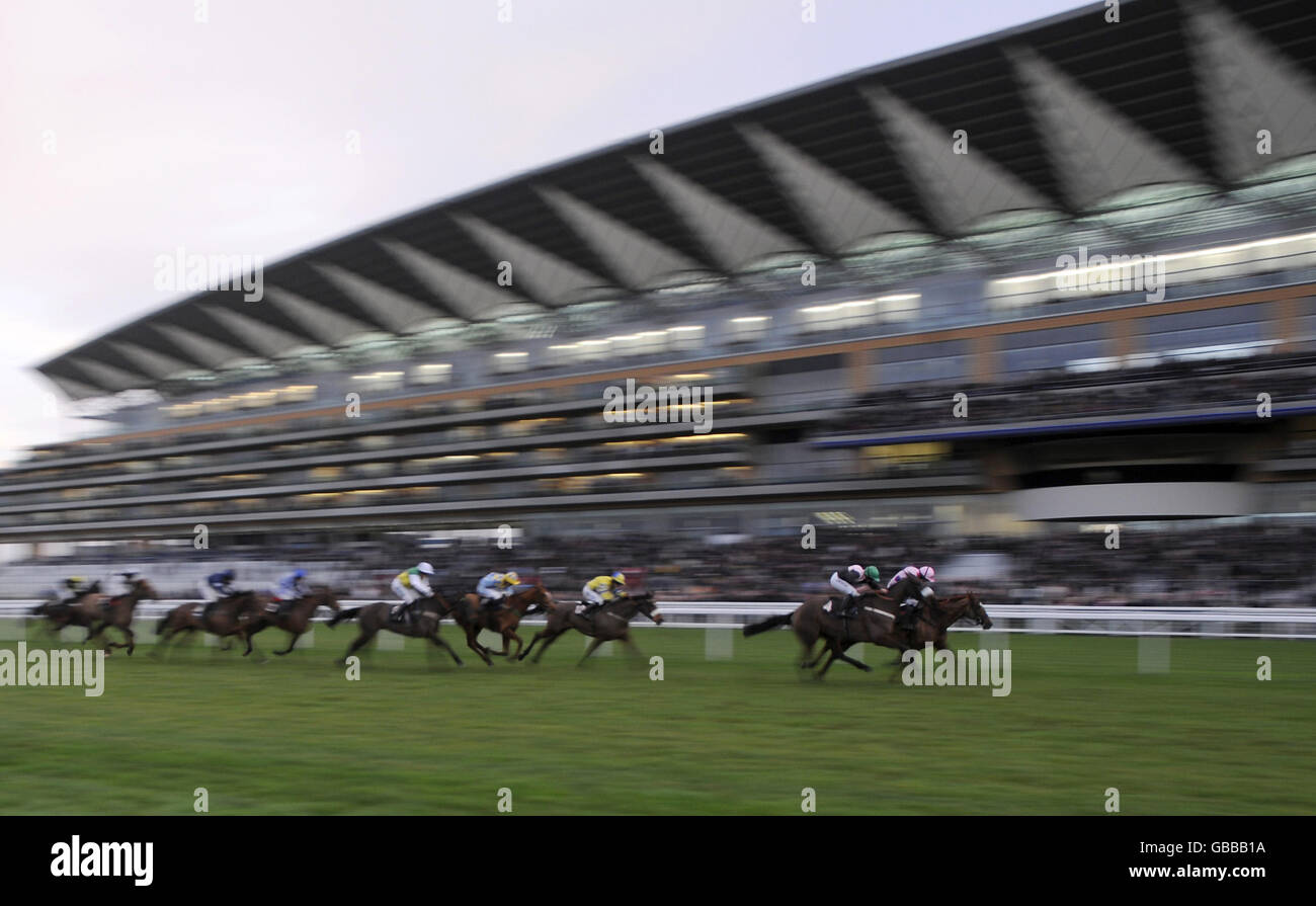 Runners and riders pass the grandstand at Ascot Racecourse, Berkshire. Stock Photo