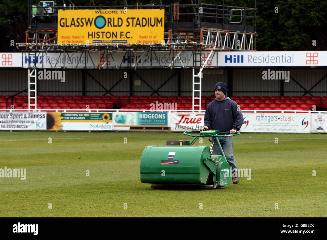 A groundsman works on the pitch at Histon Football Club, Cambridgeshire