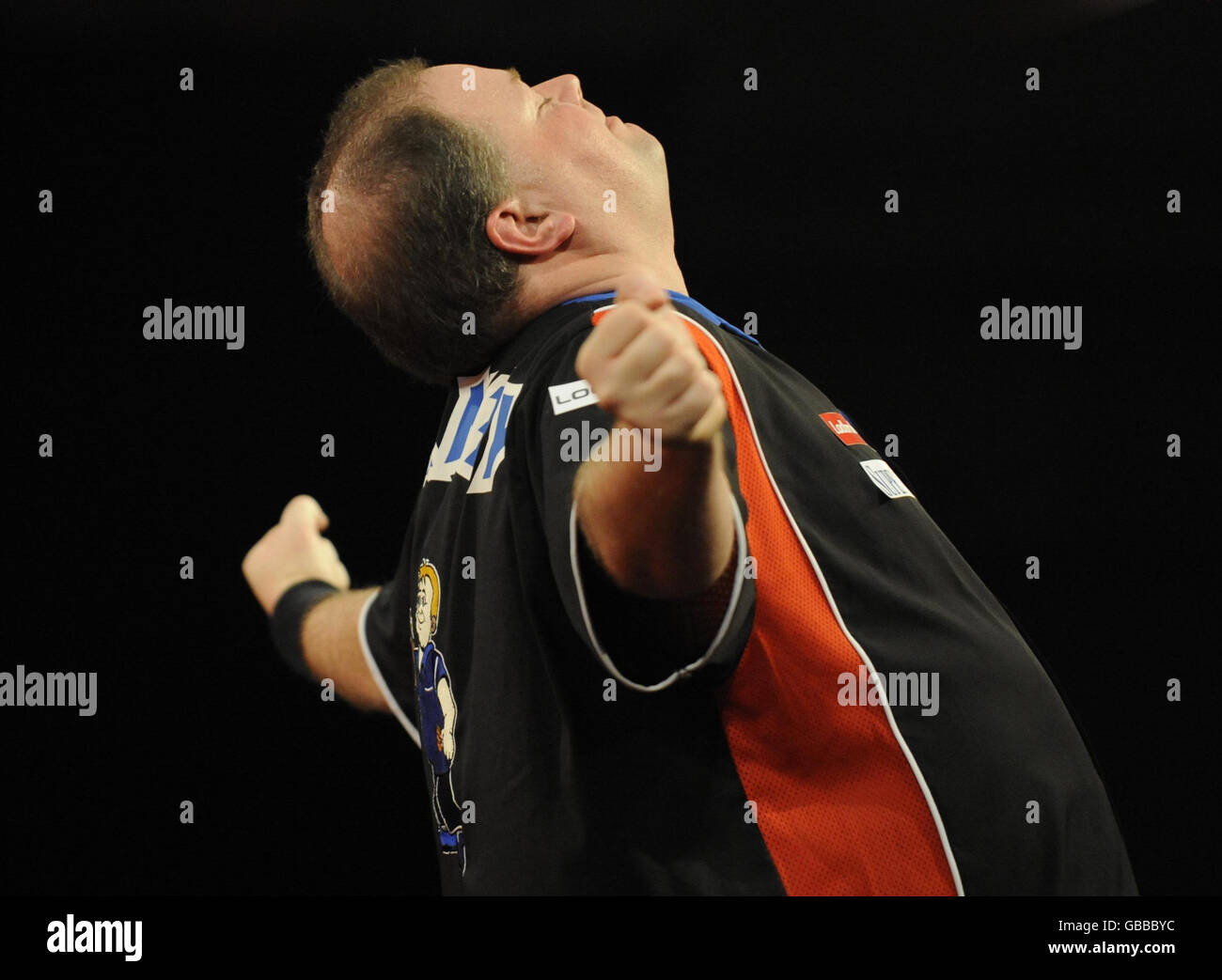 Raymond van Barneveld celebrates winning his match against Jelle Klaasen  with the help of a 9 dart finish, during the Ladbrokes.com World  Championship Quarter Finals at Alexandra Palace, London Stock Photo -