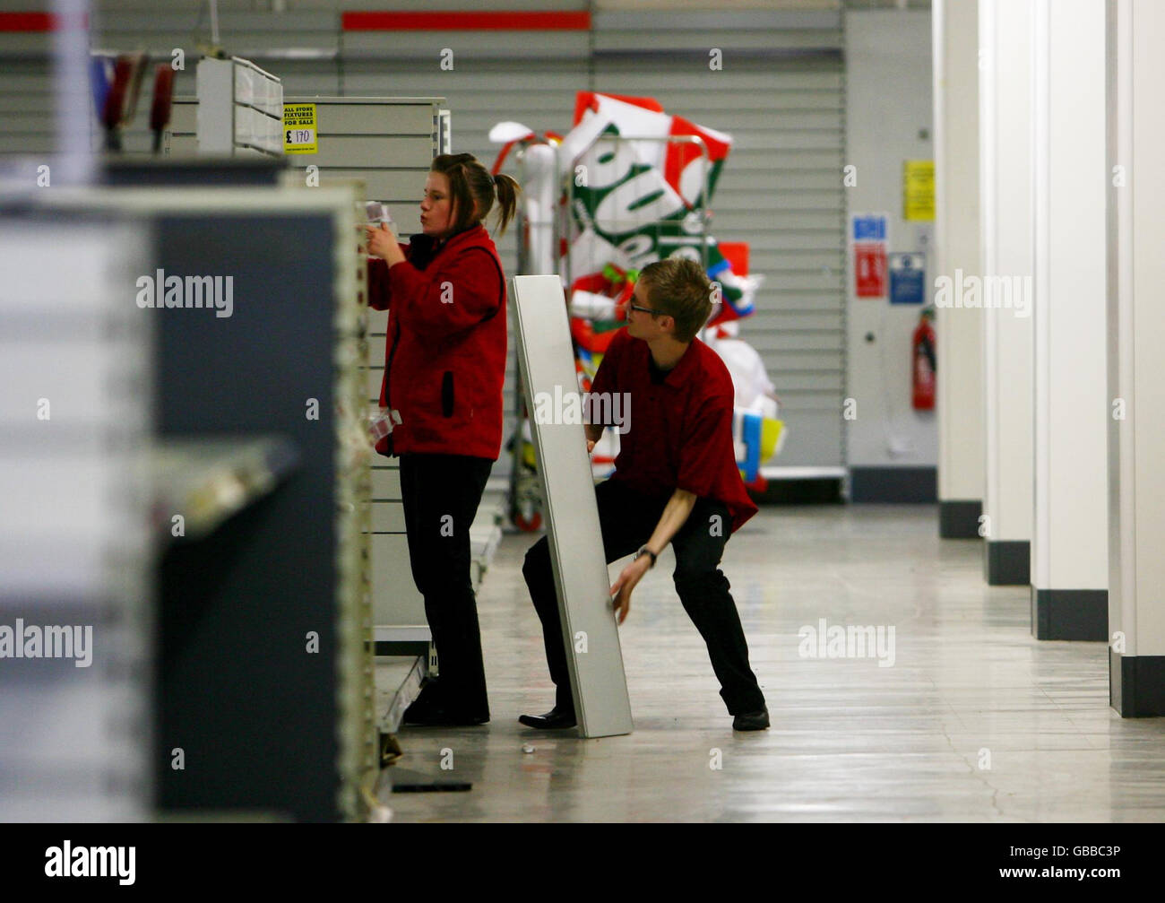 Staff members dismantle fixtures and fittings as Woolworths in