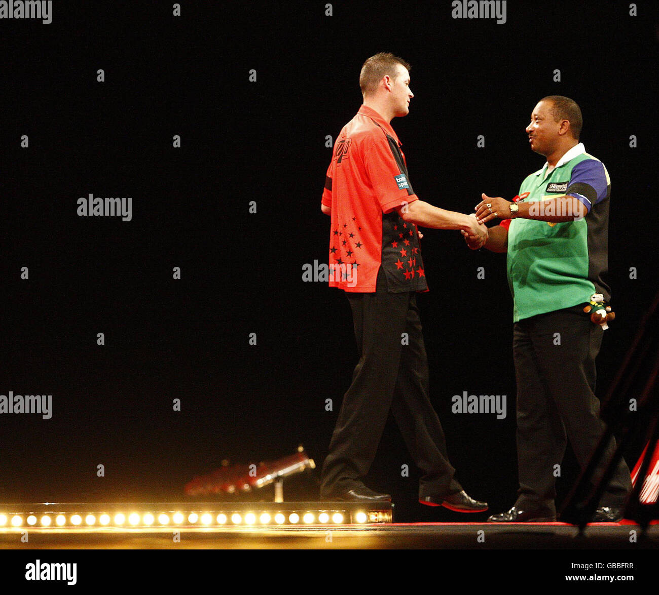 England's Colin Osborne consoles South Africa's Charles Losper after the Ladbrokes.com World Championship at Alexandra Palace, London. Stock Photo