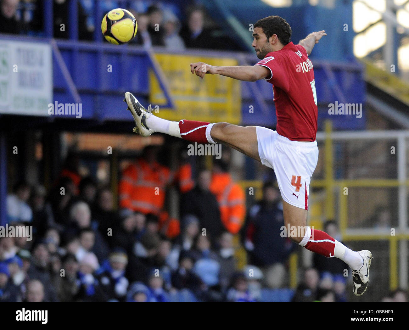 Bristol City's Liam Fontaine rises high to control the ball during the FA Cup Third Round match at Fratton Park, Portsmouth. Stock Photo